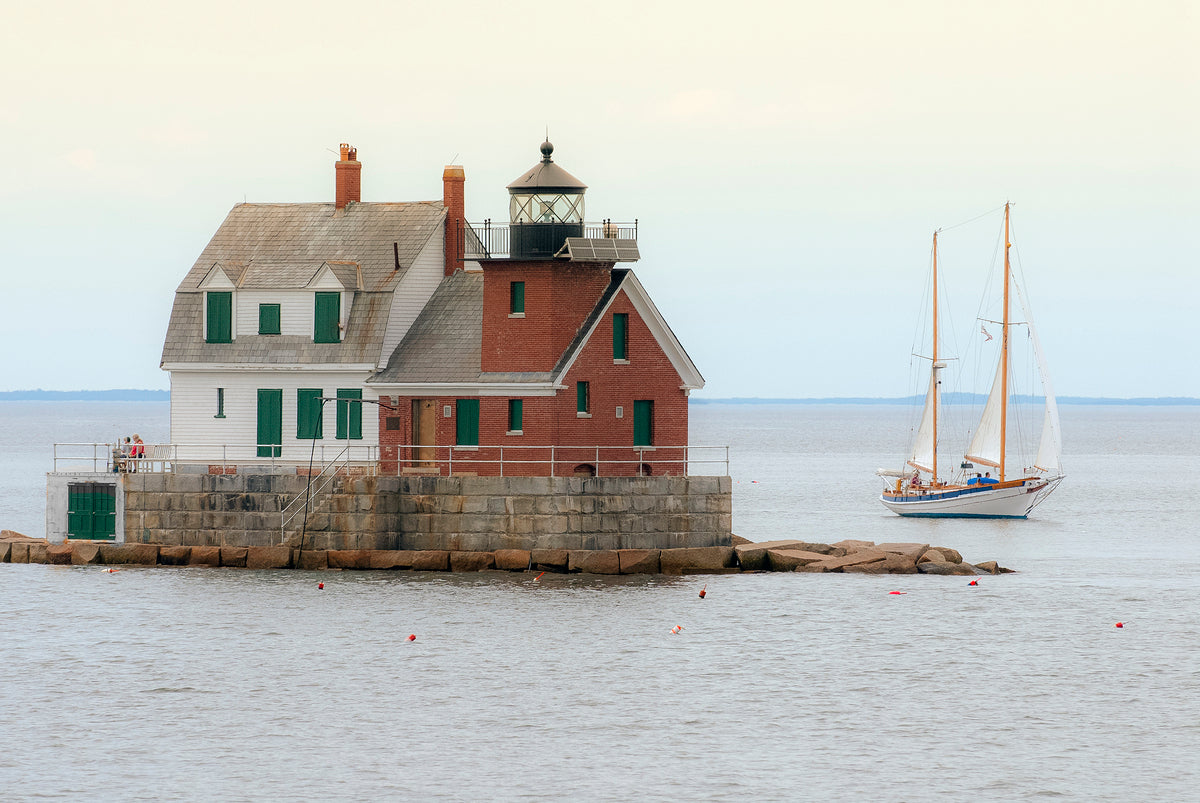 Sailboat Passes Rockland Breakwater Light on a Calm Day in Maine by Allan Wood