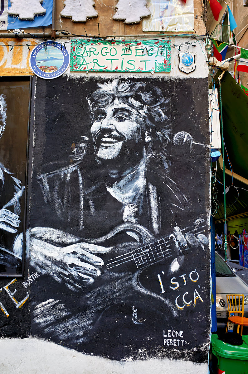 Street graffiti depicting neapolitan singer Pino Daniele at Quartieri Spagnoli Spanish Quarters by Marco Brivio