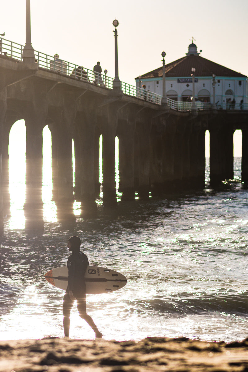 Silhouetted Pier Surfer by Sullivan Rose